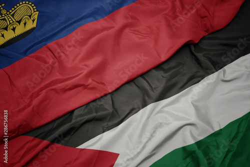 waving colorful flag of palestine and national flag of liechtenstein.
