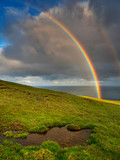 Rainbow above green hill on Faroe island. Big size.