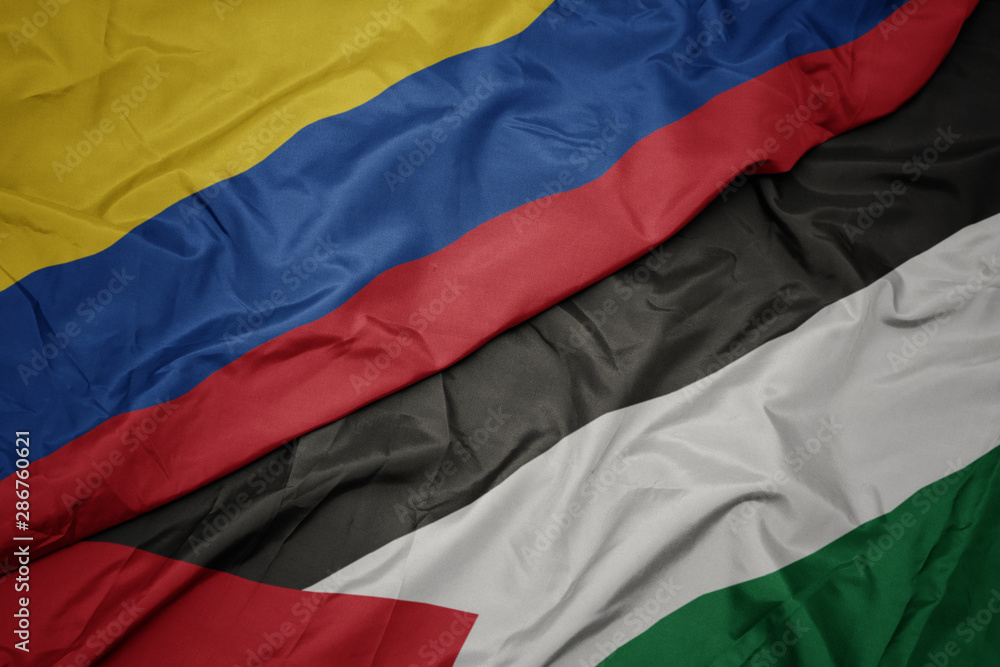 waving colorful flag of palestine and national flag of colombia.