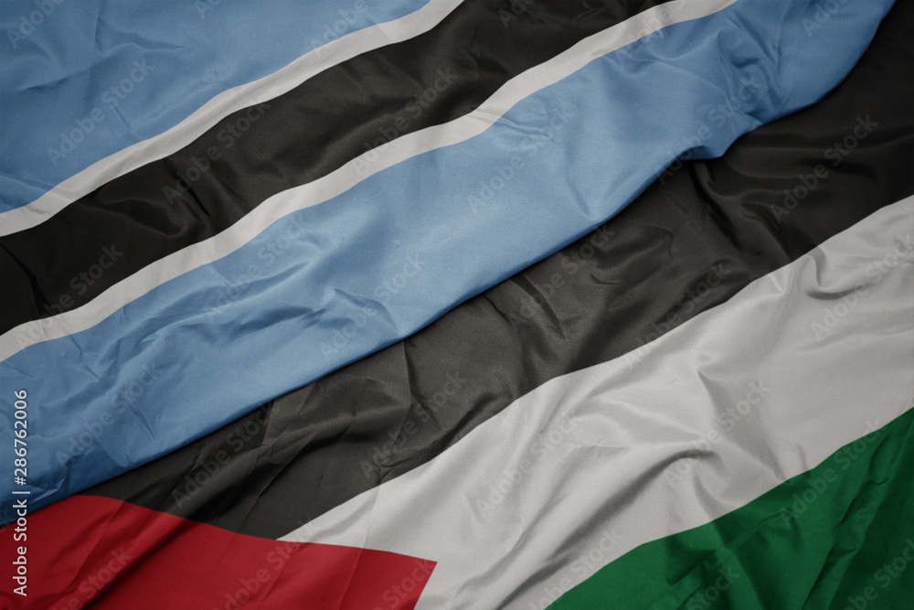 waving colorful flag of palestine and national flag of botswana. waving colorful flag of palestine and national flag of botswana.