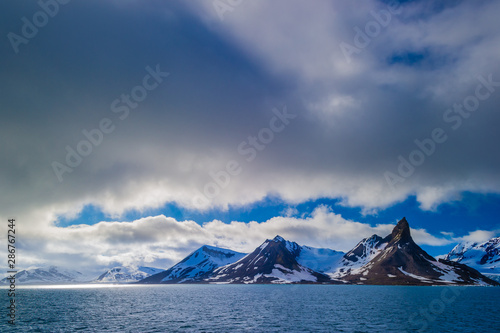 Glacier heading down from a mountain range into the Arctic Ocean, Hornsund, Norway