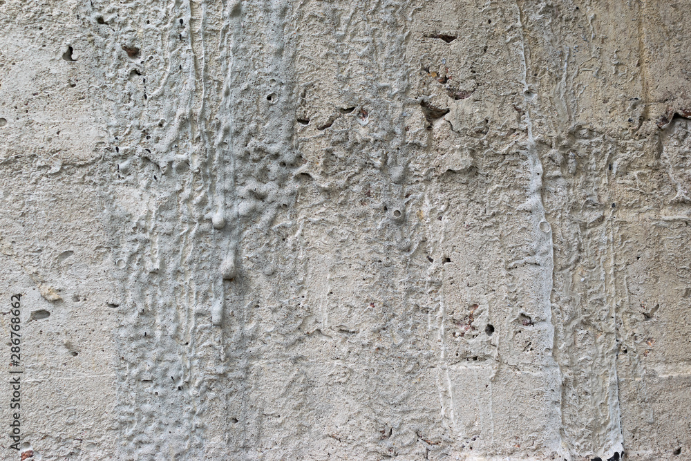 Old gray concrete wall with yellow and brown spots as an abstract background Old gray concrete wall with yellow and brown spots as an abstract background