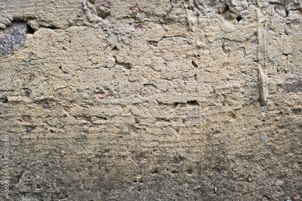 Old gray concrete wall with yellow and brown spots as an abstract background Old gray concrete wall with yellow and brown spots as an abstract background