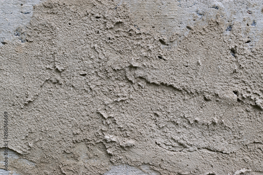 Old gray concrete wall with yellow and brown spots as an abstract background Old gray concrete wall with yellow and brown spots as an abstract background