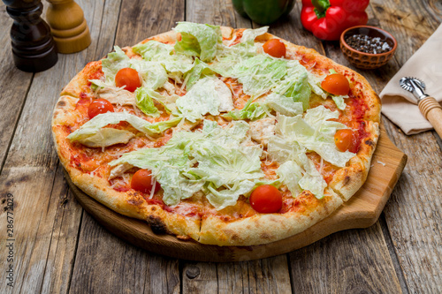 Pizza Caesar on plate on old wooden table