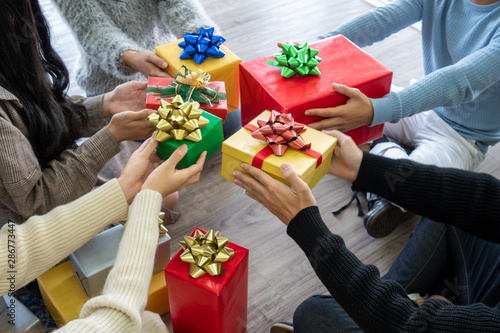 Many hands hold each Christmas gift box in Christmas eve day,Holiady concept photo