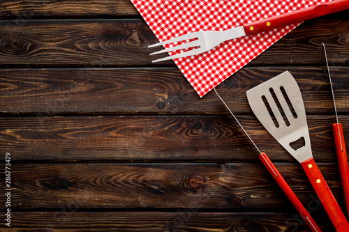 Canvas Print Tongs, fork, spatula for barbecue and grill on wooden background top view copysp