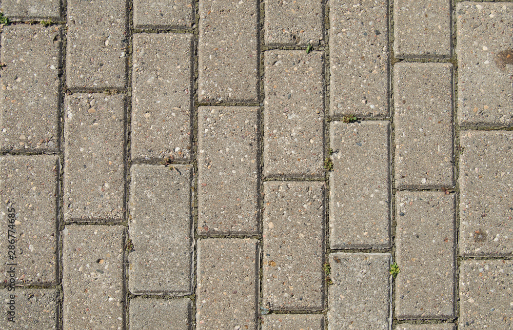 Background of stone walkway with leaves. Stone background Background of stone walkway with leaves. Stone background
