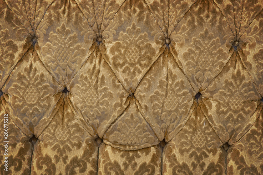 Background with upholstery of worn vintage armchair