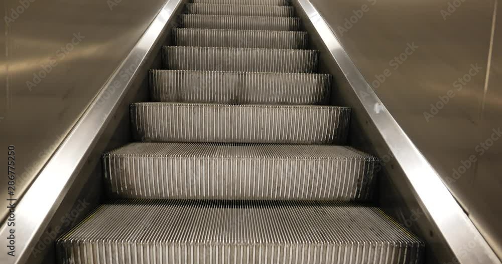 Raising up movement and close up view at rough dirty aluminium step tread and shiny balustrade of moving up escalator. Raising up movement and close up view at rough dirty aluminium step tread and shiny balustrade of moving up escalator.