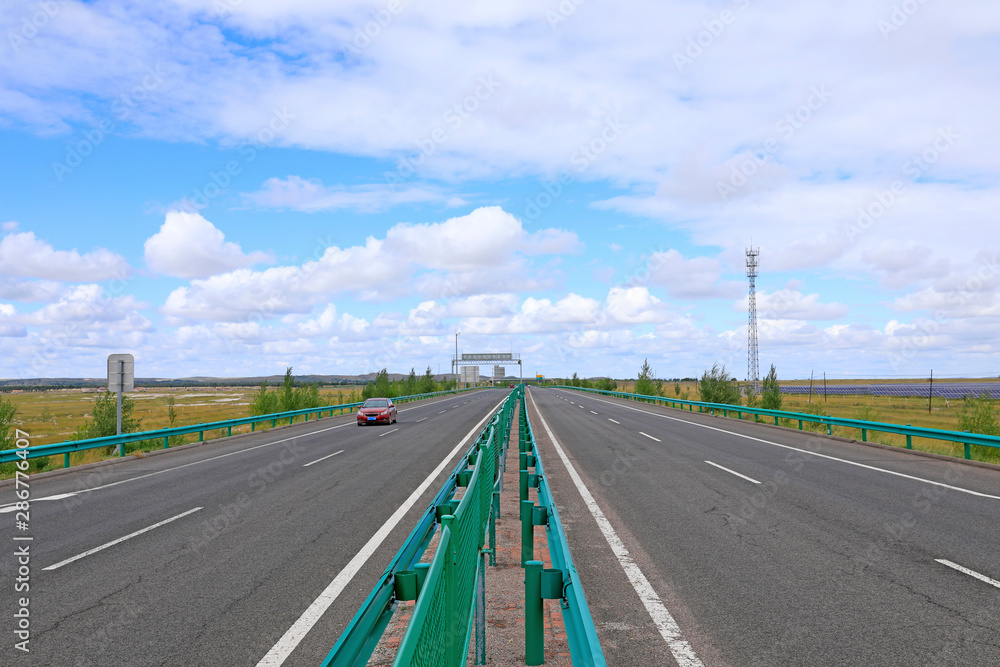 Fototapeta premium Beautiful highway, under the blue sky and white clouds