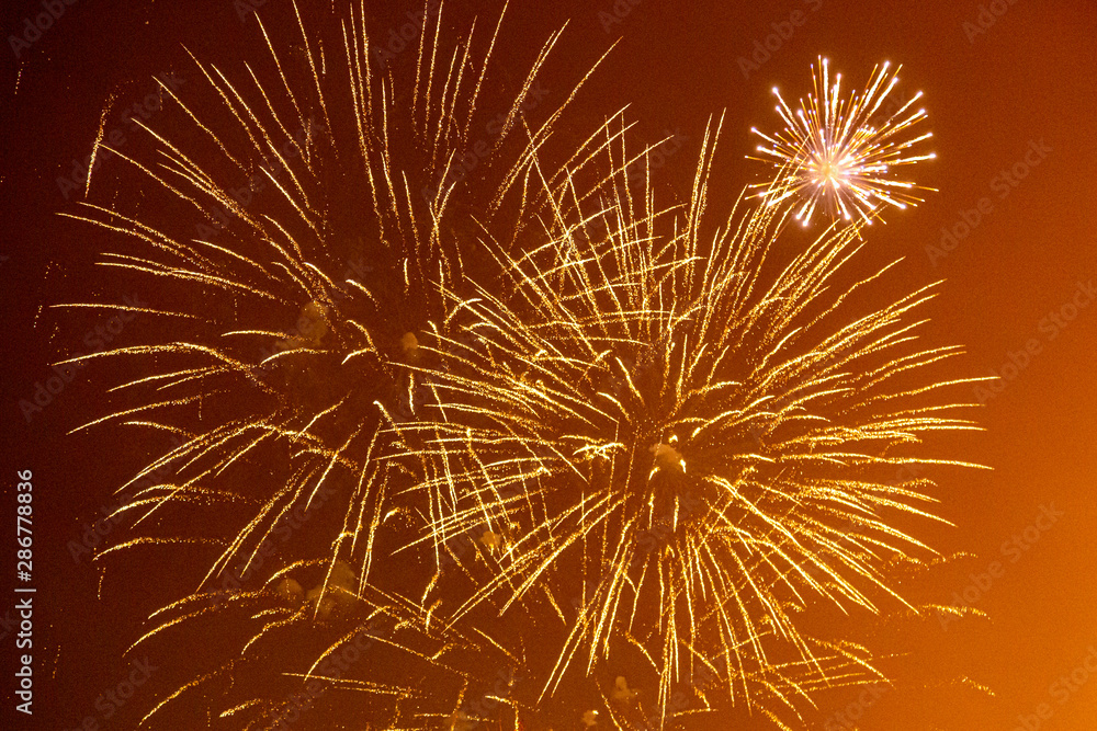 Fototapeta premium Fireworks exploding against a night sky, at Lewes bonfire celebrations