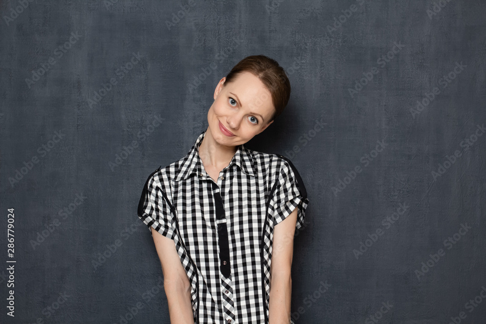 Portrait of cute young woman being in good mood and happy