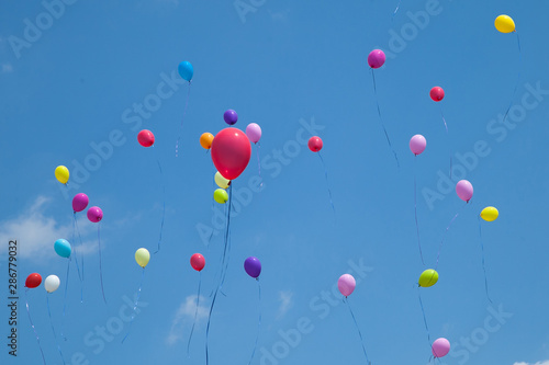 multicolored balls launched in the blue sky