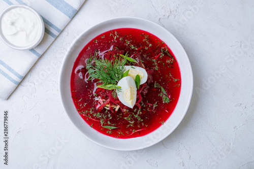 beetroot soup on bowl on white concrete table