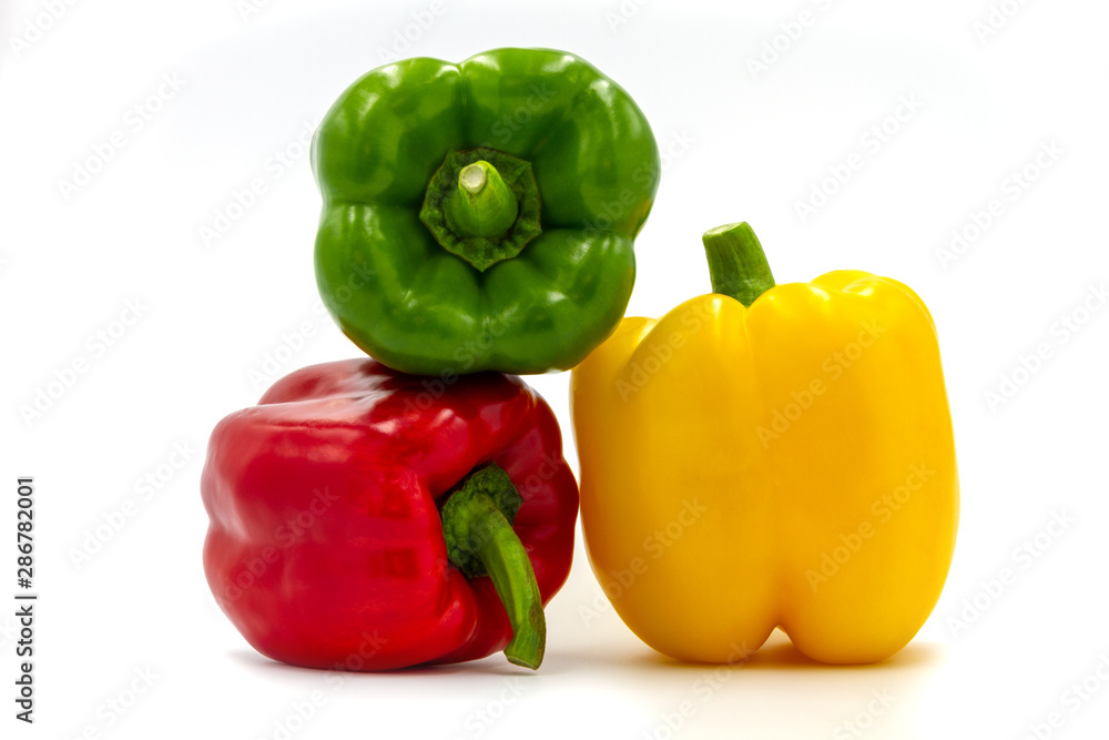 Stack of three color bell pepper on white background. Stack of three color bell pepper on white background.