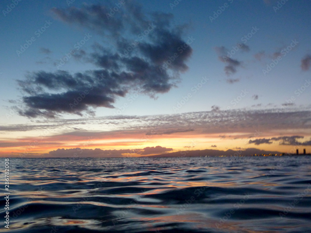 Light of Dusk illuminate the shallow ocean waters of Waikiki