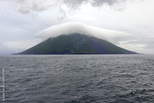 Atsonupuri Volcano of Iturup island  the Sea of Okhotsk  Kuril Islands  Russia  claimed by Japan. The top of volcano hidden in fog.
