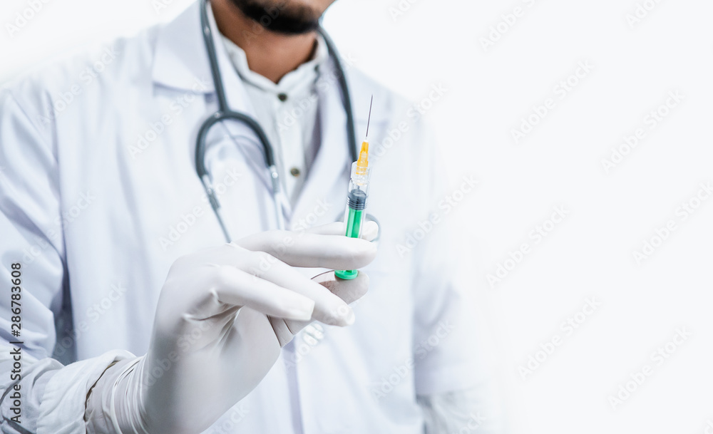 The doctor wears white gloves Holding a syringe and Vaccine bottle have text HPV . Concept Prevent HPV infection by vaccination before getting infected. The doctor wears white gloves Holding a syringe and Vaccine bottle have text HPV . Concept Prevent HPV infection by vaccination before getting infected.