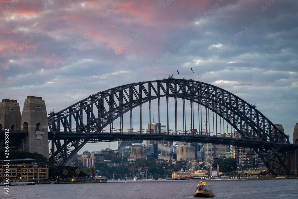 sydney harbour bridge in australia with red sky sunset