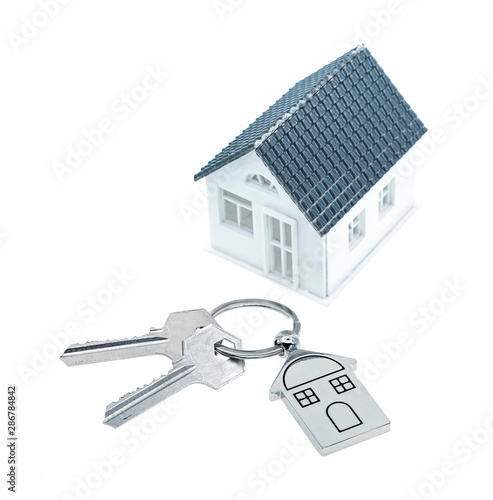 key chain with house symbol and keys on white background,Real estate concept