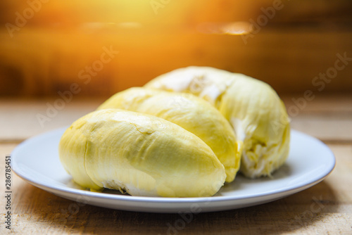 Fresh durian peel tropical fruit summer on white plate and wooden