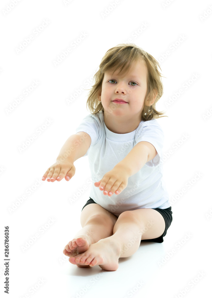 Charming little girl doing gymnastic exercises in the studio on Charming little girl doing gymnastic exercises in the studio on