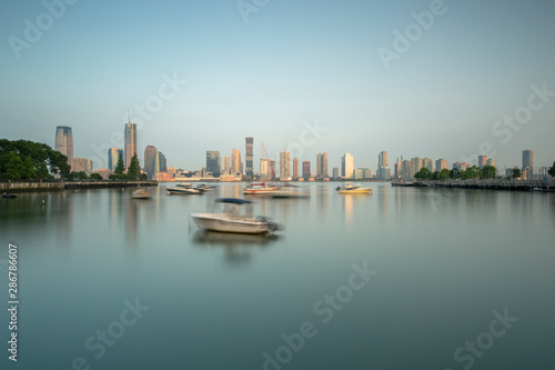 Fototapeta Naklejka Na Ścianę i Meble -  Manhattan Yacht club wit jersey city on background at sunrise with long exposure