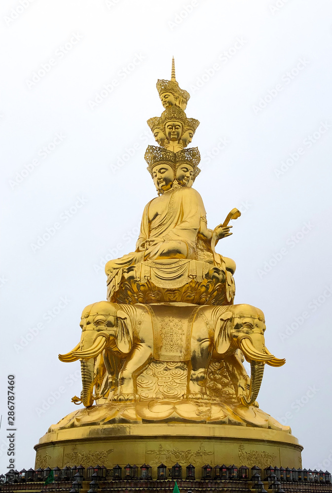 Golden Puxian statue of Mt. Emei on a foggy day
