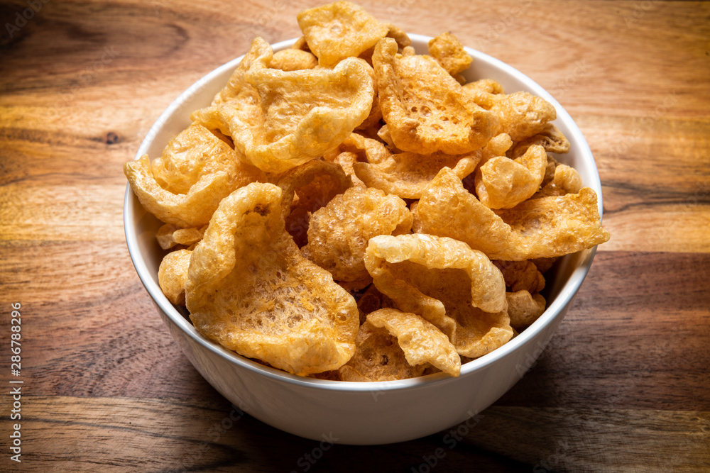 White Bowl of Fried chicharrones (pork rind) White Bowl of Fried chicharrones (pork rind)