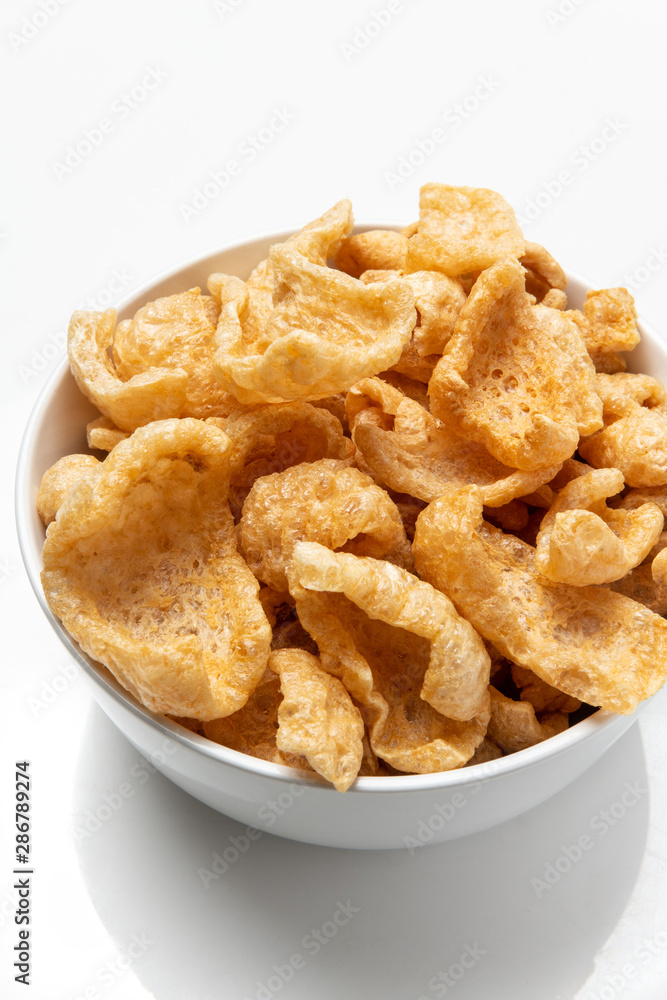 White Bowl of Fried chicharrones (pork rind) White Bowl of Fried chicharrones (pork rind)