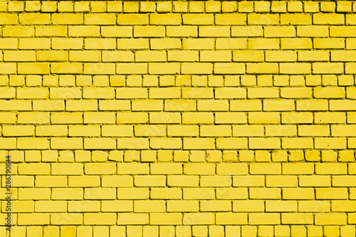 Yellow colored brick background. Brick wall.