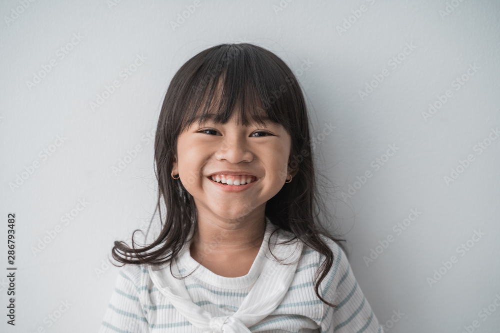 toothy smiling little girl in isolated background toothy smiling little girl in isolated background