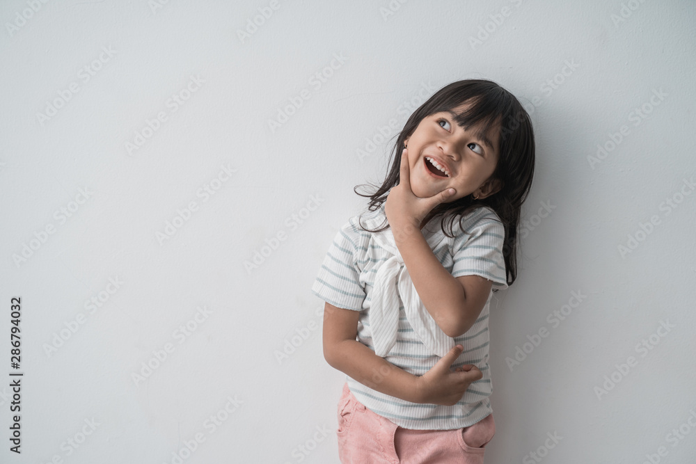asian cute little girl surprised looking up in isolated background asian cute little girl surprised looking up in isolated background
