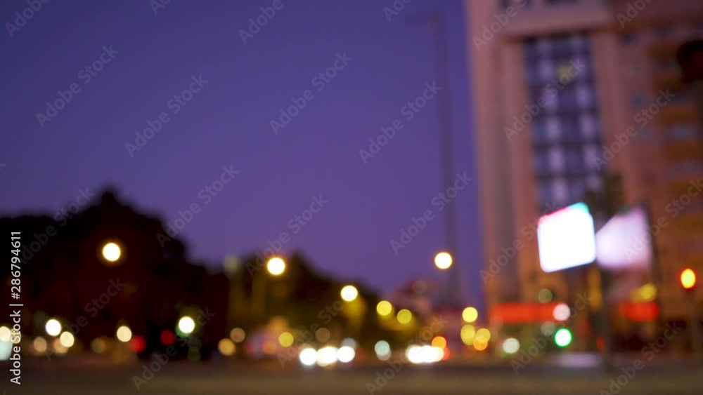 Ancient city square at night with cars passing, motorcycles by at rush hour Ancient city square at night with cars passing, motorcycles by at rush hour