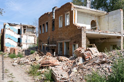 facade destroyed brick building. concept war, destruction, demolition, earthquakes, looting