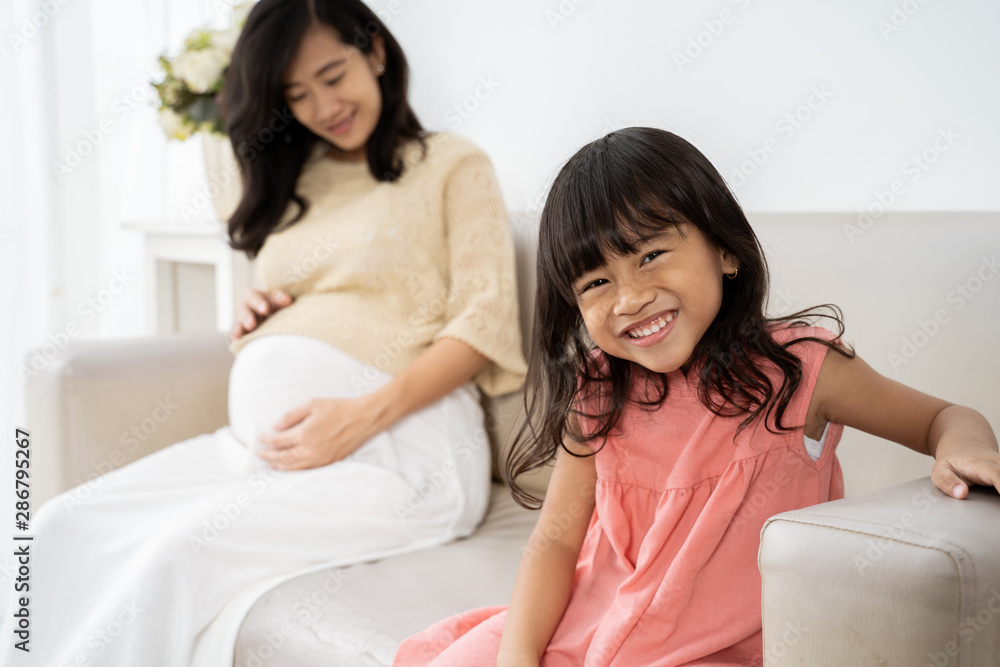 cute smiling girl with asian mother pregnant background cute smiling girl with asian mother pregnant background