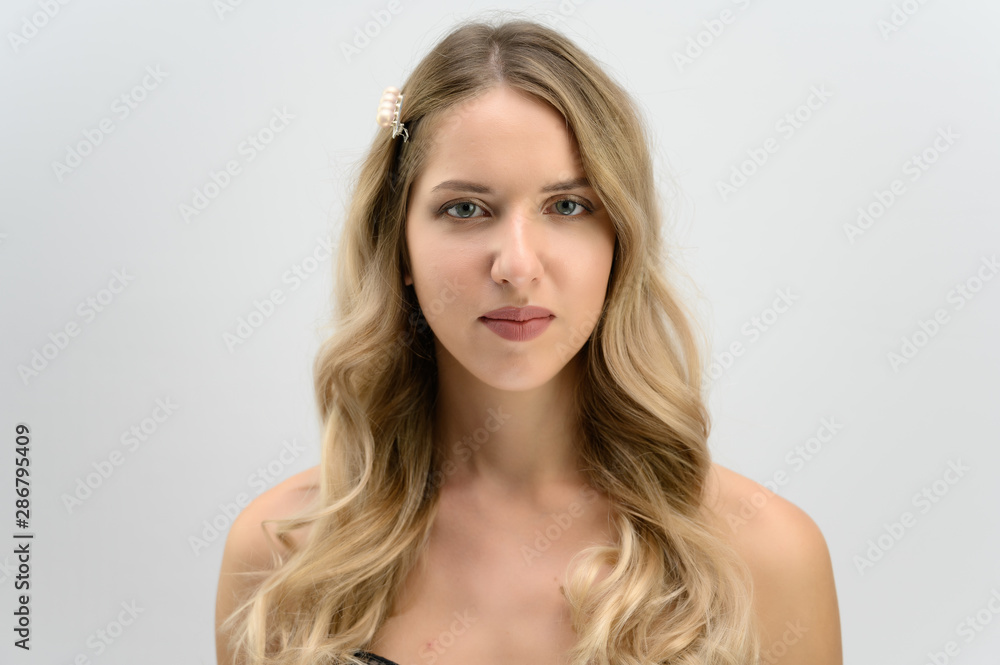 A large photo portrait of a pretty model with long hair and a beautiful hairstyle on a white background. A large photo portrait of a pretty model with long hair and a beautiful hairstyle on a white background.