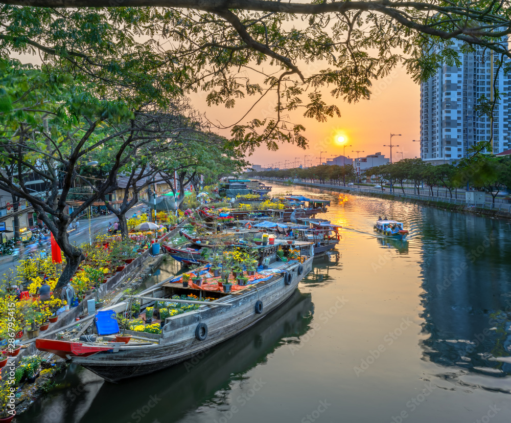 Ho Chi Minh City, Vietnam - February 3rd, 2019: Sunset boat dock flower market along canal wharf. This is place farmers sell apricot and other flowers on Lunar New Year in Ho Chi Minh city, Vietnam Ho Chi Minh City, Vietnam - February 3rd, 2019: Sunset boat dock flower market along canal wharf. This is place farmers sell apricot and other flowers on Lunar New Year in Ho Chi Minh city, Vietnam