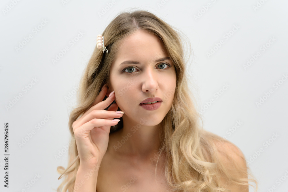 A large photo portrait of a pretty model with long hair and a beautiful hairstyle on a white background. A large photo portrait of a pretty model with long hair and a beautiful hairstyle on a white background.