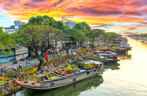 Obraz na płótnie Ho Chi Minh City, Vietnam - February 3rd, 2019: Sunset boat dock flower market along canal wharf
