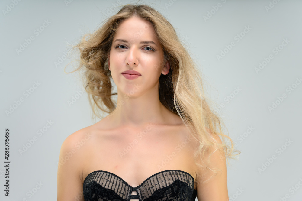 A large photo portrait of a pretty model with long flowing hair and a beautiful hairstyle on a white background.