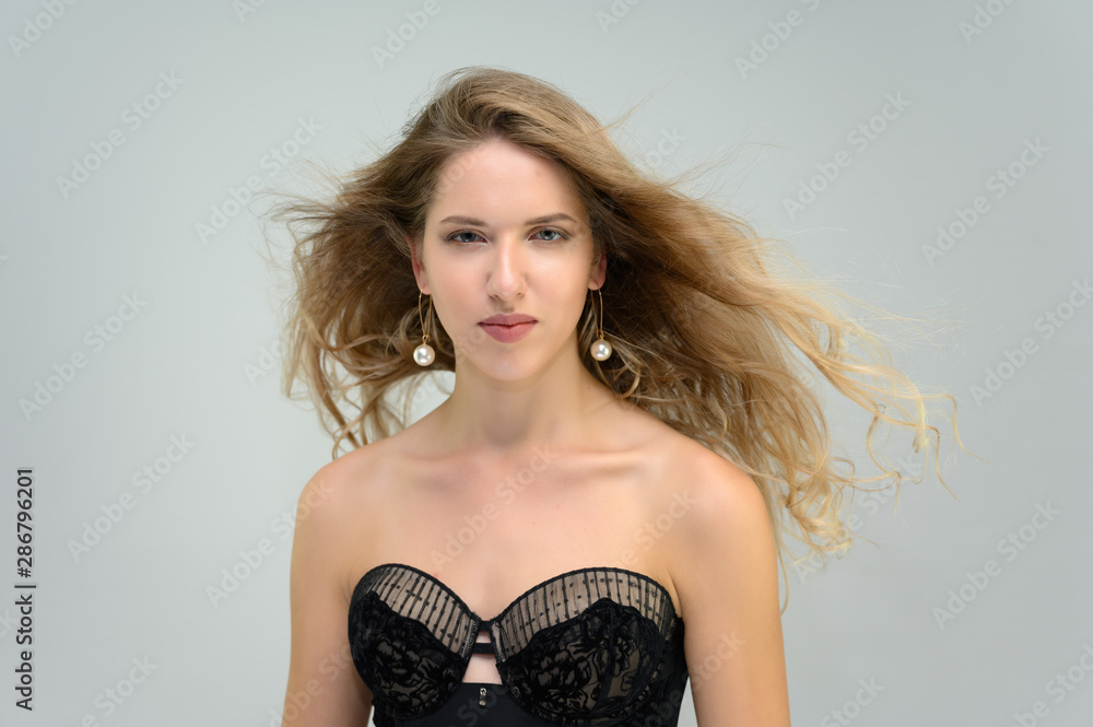 A large photo portrait of a pretty model with long flowing hair and a beautiful hairstyle on a white background. A large photo portrait of a pretty model with long flowing hair and a beautiful hairstyle on a white background.