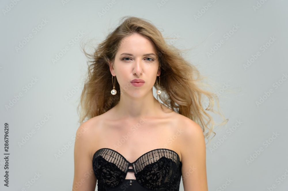 A large photo portrait of a pretty model with long flowing hair and a beautiful hairstyle on a white background. A large photo portrait of a pretty model with long flowing hair and a beautiful hairstyle on a white background.