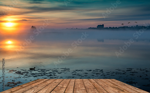 Colorful landscape with sunrise and a mist above a river, summer morning in E...