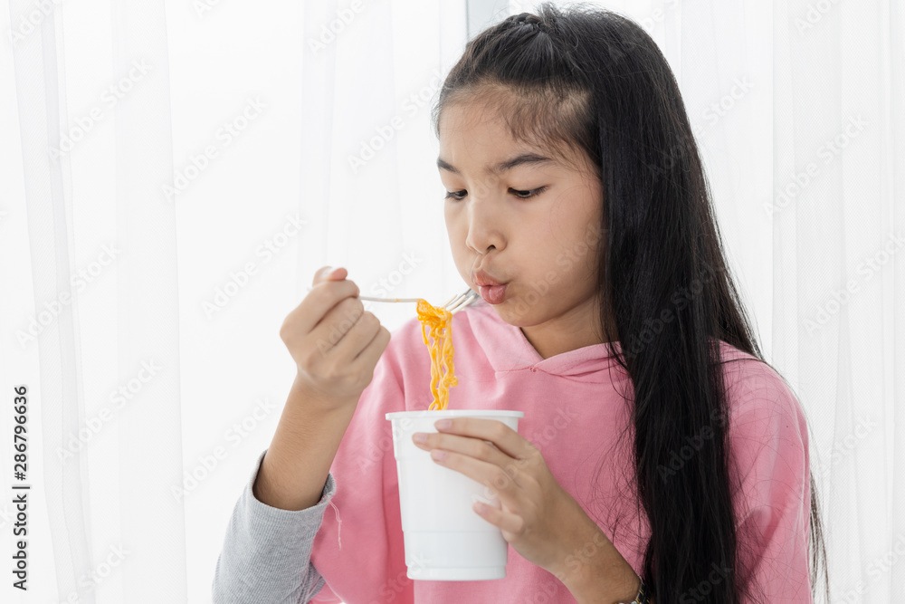 thai asian girl eating instant noodles thai asian girl eating instant noodles