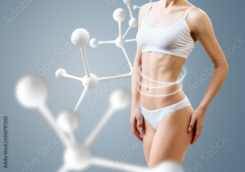 Woman with perfect body near molecule chain. Slimming concept.