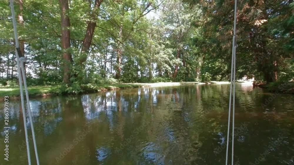 POV boat riding through woodland on river POV boat riding through woodland on river