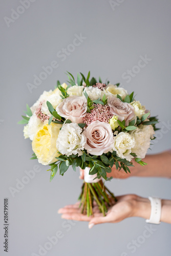 Bridal bouquet. Beautiful bouquet of mixed flowers in woman hand. Floral shop concept . Handsome fresh bouquet. Flowers delivery