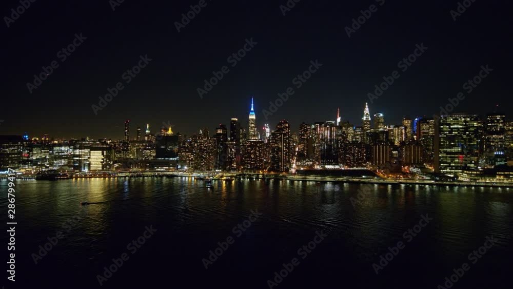 NYC New York Aerial v102 Low to high nighttime cityscape moving over East River into Midtown Manhattan with FDR traffic - October 2017 NYC New York Aerial v102 Low to high nighttime cityscape moving over East River into Midtown Manhattan with FDR traffic - October 2017